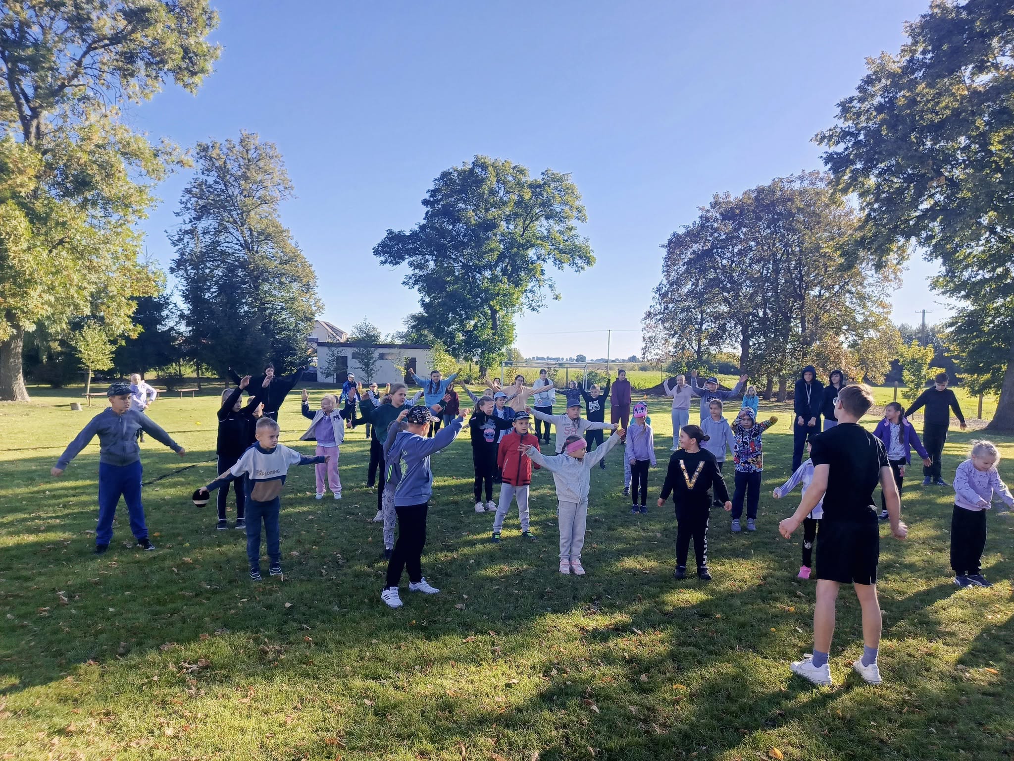 Uczniowie podczas rozgrzewki na boisku szkolnym