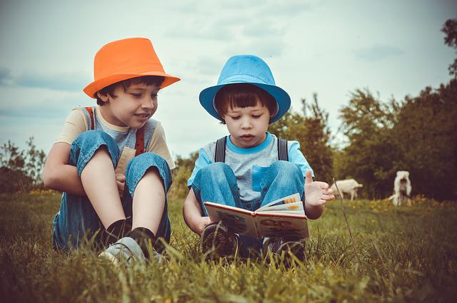 Grafika ilustrująca chłopców czytających książkę