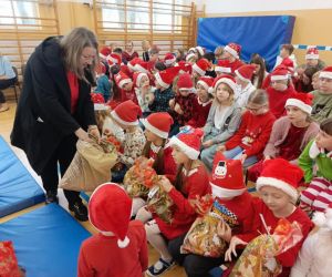 Pani elf rozdaje cukierki uczniom