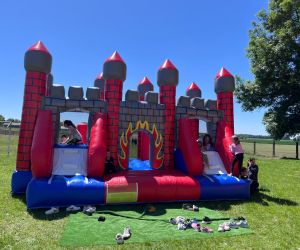 Uczniowie bawią się na dmuchanym zamku