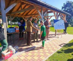 Dyrektor szkoły w Czerniczynie i Sekretarz Gminy Hrubieszów wręczają uczniowi dyplom i nagrodę