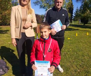 Dyrektor szkoły, nauczyciel wychowania fizycznego i uczeń klasy pierwszej, zdobywca trzeciego miejsca