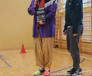 Klaun daje uczniowi znak do zagrania roli filmowej