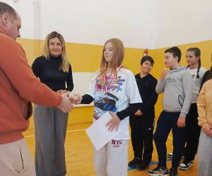 Nauczyciel wychowania fizycznego składa gratulacje uczennicy klasy szóstej