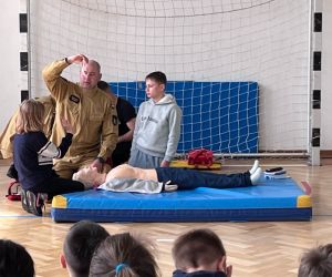uczniowie podczas ćwiczeń ze strażakami z udzielania pierwszej pomocy