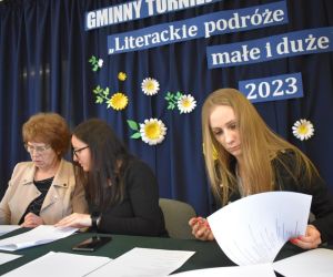 Na zdjęciu widoczne są trzy osoby dorosłe siedzące przy stole.