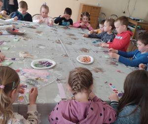 Zdjęcie przedstawia dzieci siedzące przy stole.