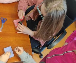 Na zdjęciu widoczne osoby wykonujące prace plastyczną.