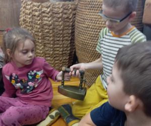 Uczeń trzyma w ręku stare żelazko