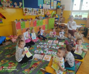 Dzieci siedzą w kole. W tle napis Dzień Postaci z Bajek.