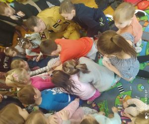 Dzieci ćwiczą na fantomie udzielanie pierwszej pomocy.