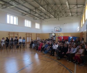 Nauczyciele i uczniowie zgromadzeni w sali gimnastycznej